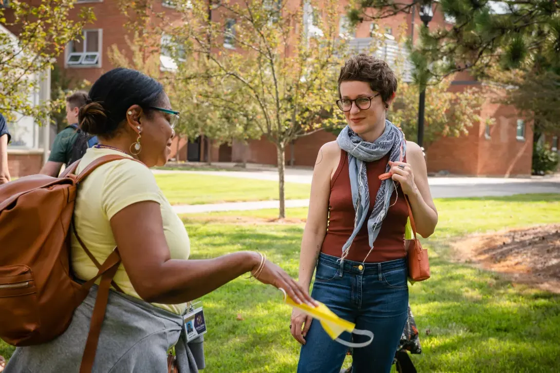 MFA Summer Residency participants talking to each other on campus